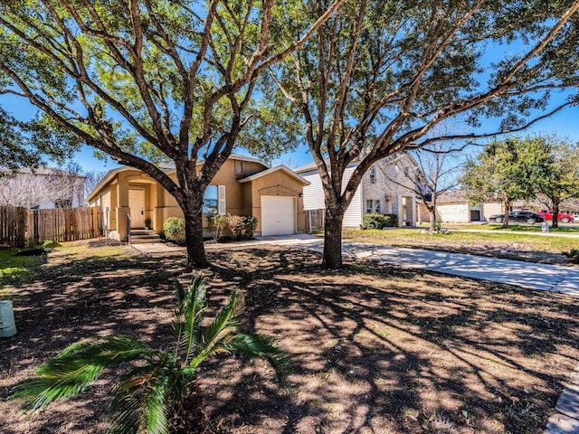 171 Beech Dr, Kyle, TX 78640 - view of front of house featuring stucco siding, an attached garage, and driveway