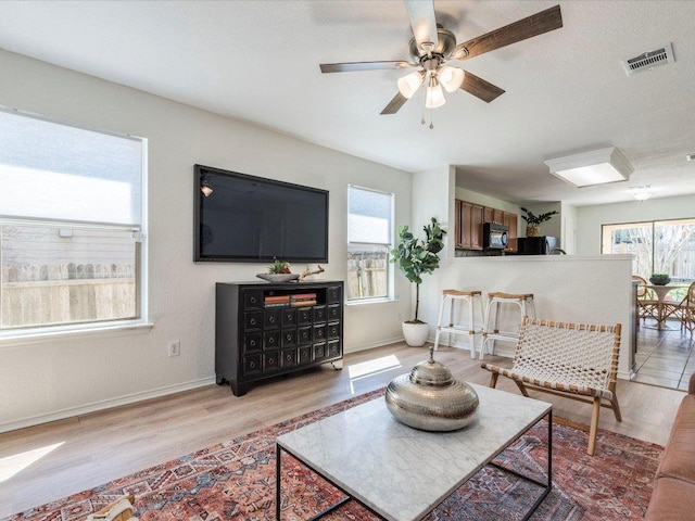 171 Beech Dr, Kyle, TX 78640 - living room with light wood-type flooring, a ceiling fan, and baseboards