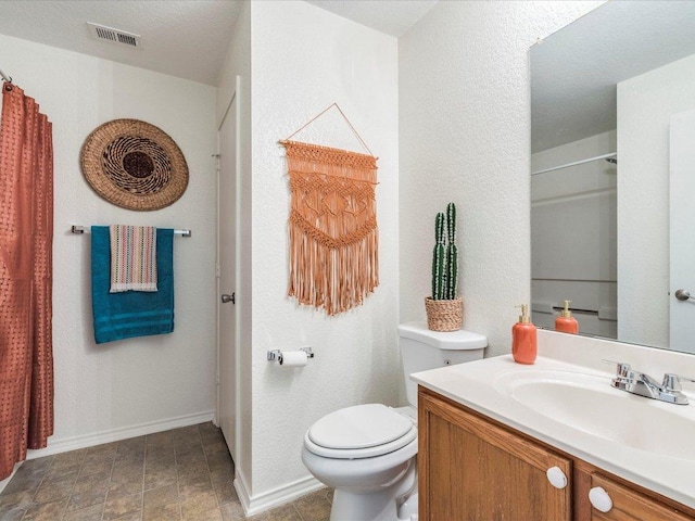 171 Beech Dr, Kyle, TX 78640 - bathroom featuring vanity, toilet, a shower with shower curtain, baseboards, and a textured wall