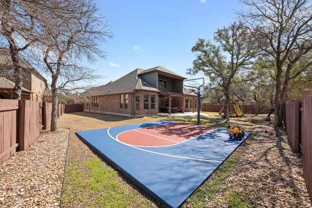 view of sport court featuring a fenced backyard and basketball court