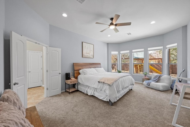 bedroom with light carpet, visible vents, and recessed lighting