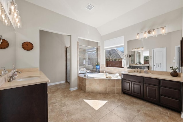 bathroom featuring a sink, visible vents, vaulted ceiling, a shower stall, and a bath