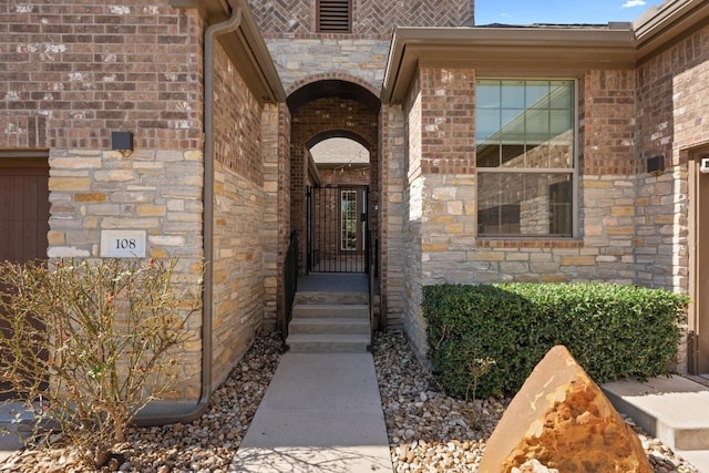 entrance to property featuring brick siding