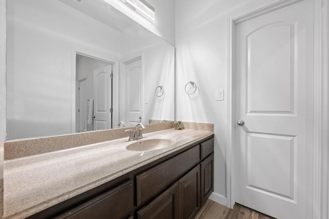 bathroom featuring wood finished floors and vanity