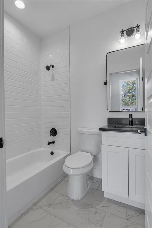 full bathroom with marble finish floor, shower / bathing tub combination, vanity, and toilet