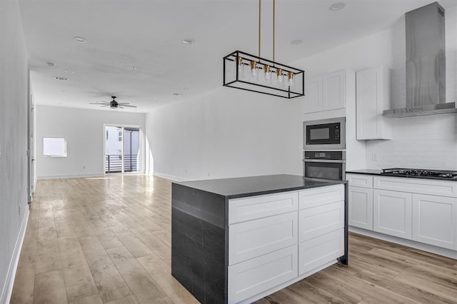 kitchen featuring dark countertops, wall chimney exhaust hood, oven, built in microwave, and black cooktop