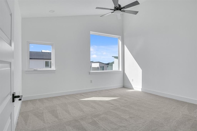 spare room featuring carpet floors, high vaulted ceiling, baseboards, and a ceiling fan