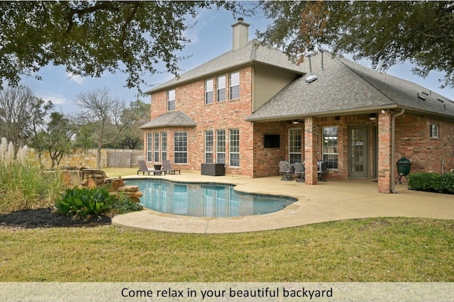 view of pool featuring a yard, a patio area, and fence