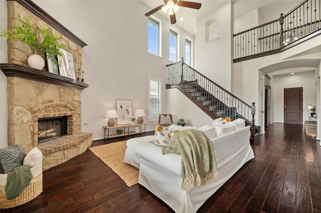 5305 Cardinal Flower Cv, Spicewood, TX 78669 - living area with wood-type flooring, a ceiling fan, a high ceiling, arched walkways, and stairs