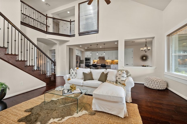 5305 Cardinal Flower Cv, Spicewood, TX 78669 - living area with hardwood / wood-style flooring, a towering ceiling, baseboards, stairway, and ceiling fan