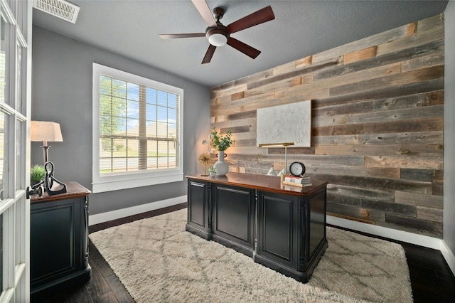 5305 Cardinal Flower Cv, Spicewood, TX 78669 - office area with wood walls, ceiling fan, baseboards, an accent wall, and wood finished floors