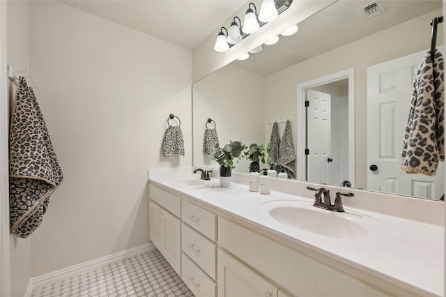 5305 Cardinal Flower Cv, Spicewood, TX 78669 - bathroom with double vanity, baseboards, and tile patterned floors