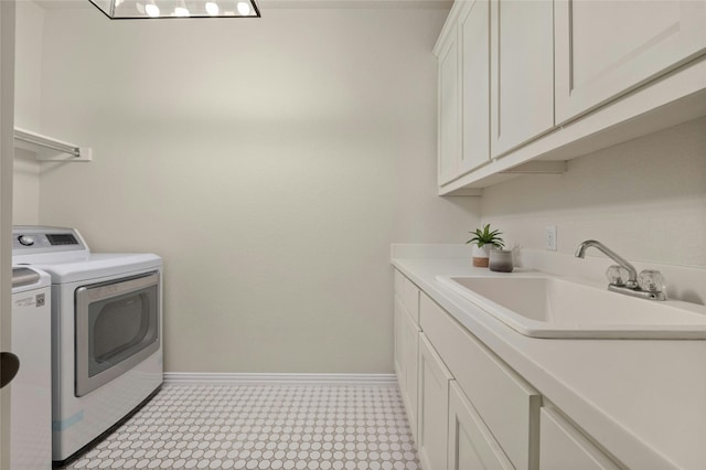 5305 Cardinal Flower Cv, Spicewood, TX 78669 - laundry room with washer and dryer, cabinet space, baseboards, and light flooring