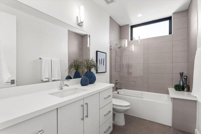 bathroom featuring tile patterned flooring, vanity, toilet, and shower / bathtub combination