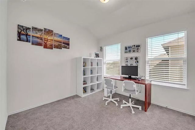 carpeted office space featuring lofted ceiling