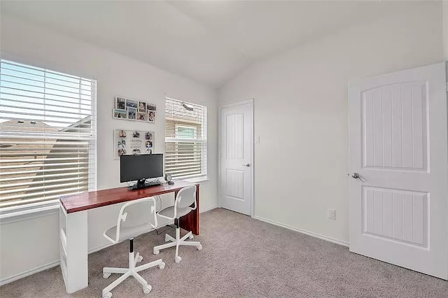 office area featuring lofted ceiling, carpet floors, and baseboards