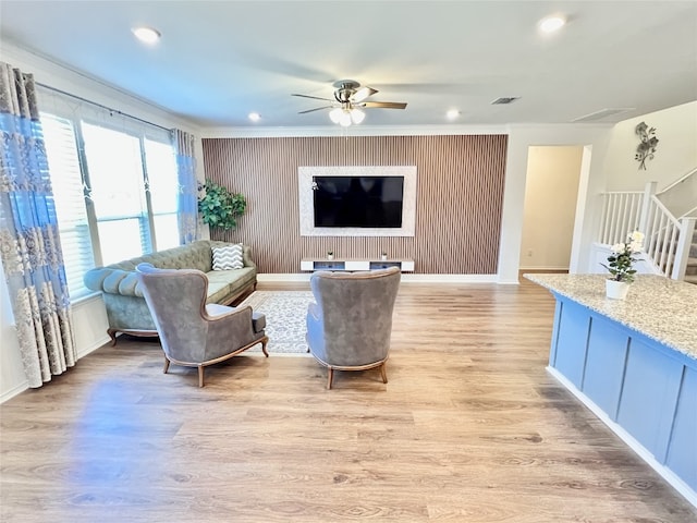 living area with ceiling fan, recessed lighting, visible vents, stairway, and light wood-type flooring