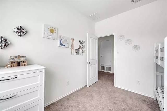 unfurnished bedroom with light carpet, visible vents, and baseboards