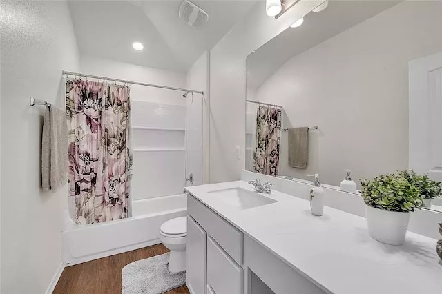 full bath with visible vents, toilet, shower / tub combo with curtain, wood finished floors, and vanity