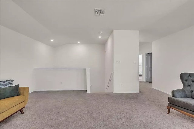 sitting room featuring recessed lighting, carpet flooring, visible vents, and an upstairs landing