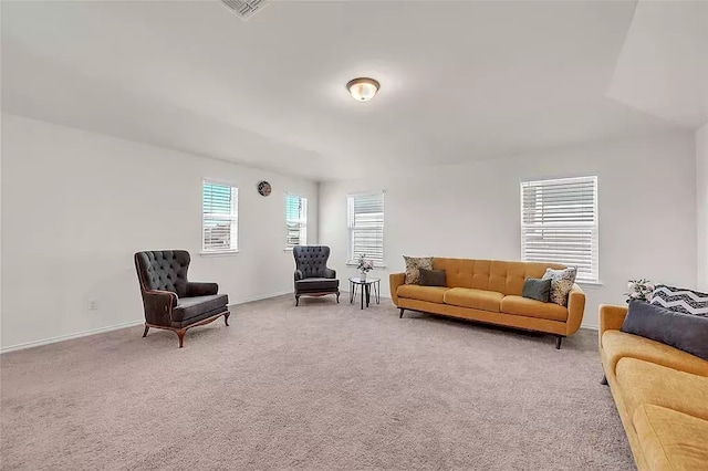 carpeted living area featuring baseboards