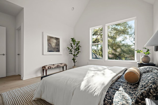5107 Menchaca Rd Unit 11, Austin, TX 78745 - bedroom with light wood-type flooring, multiple windows, and high vaulted ceiling