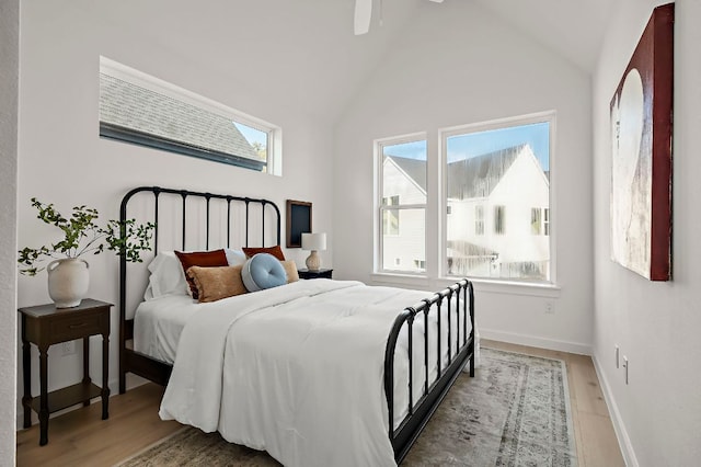 5107 Menchaca Rd Unit 11, Austin, TX 78745 - bedroom with wood finished floors, ceiling fan, and high vaulted ceiling