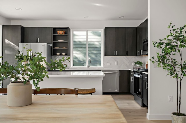 5107 Menchaca Rd Unit 11, Austin, TX 78745 - kitchen with stainless steel appliances, light wood-type flooring, light countertops, tasteful backsplash, and recessed lighting