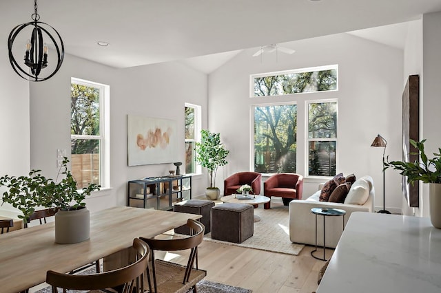 living room featuring light wood-type flooring, vaulted ceiling, and ceiling fan