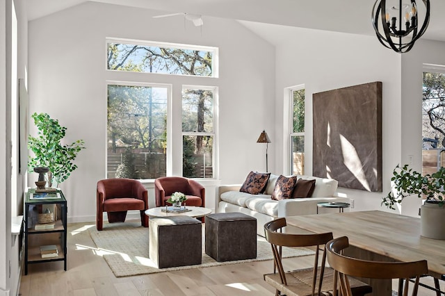 5107 Menchaca Rd Unit 11, Austin, TX 78745 - living room featuring light wood-style floors, a chandelier, and high vaulted ceiling