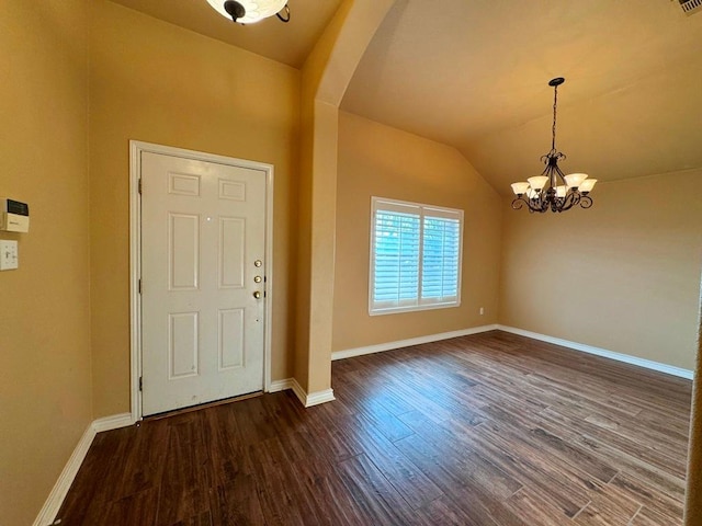 entrance foyer with baseboards, dark wood-style flooring, arched walkways, vaulted ceiling, and a notable chandelier