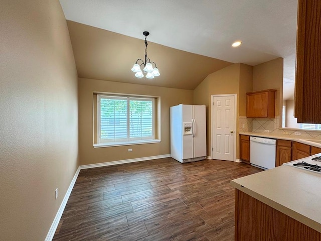 627 Columbine Ave, Cedar Park, TX 78613 - kitchen with white appliances, vaulted ceiling, dark wood finished floors, baseboards, and brown cabinets