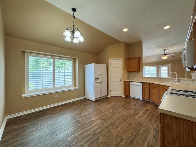 627 Columbine Ave, Cedar Park, TX 78613 - kitchen with white appliances, a sink, lofted ceiling, plenty of natural light, and a chandelier