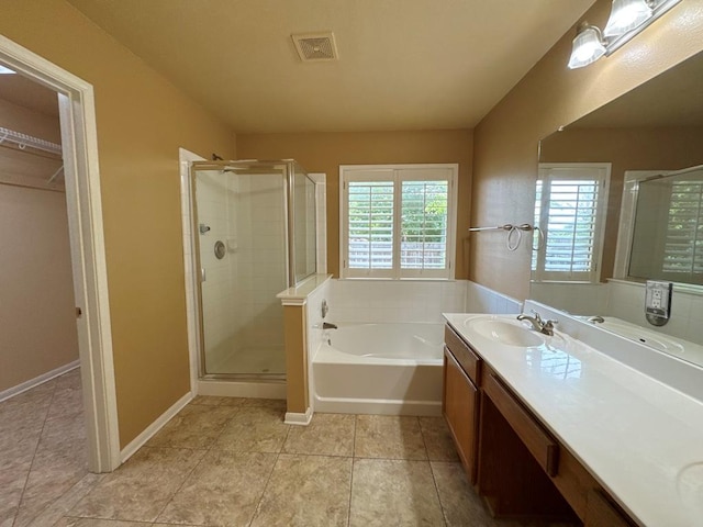 627 Columbine Ave, Cedar Park, TX 78613 - full bath featuring a garden tub, a stall shower, vanity, and a walk in closet