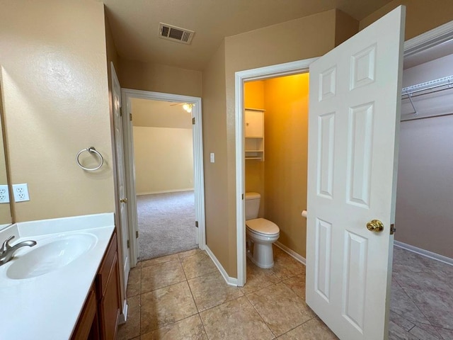 627 Columbine Ave, Cedar Park, TX 78613 - bathroom with toilet, vanity, tile patterned flooring, baseboards, and ceiling fan
