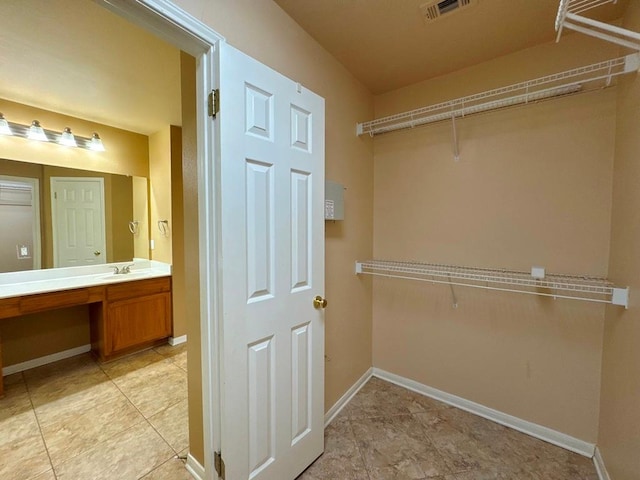 627 Columbine Ave, Cedar Park, TX 78613 - spacious closet featuring a sink and light tile patterned floors