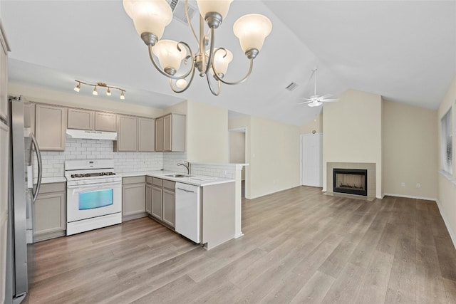 kitchen with white appliances, visible vents, gray cabinetry, under cabinet range hood, and open floor plan