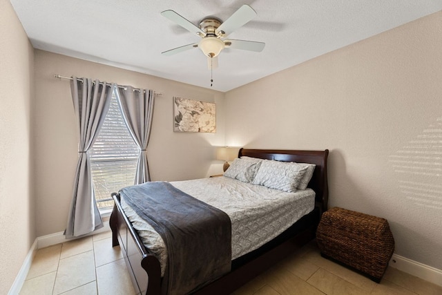 bedroom with a ceiling fan, light tile patterned flooring, and baseboards