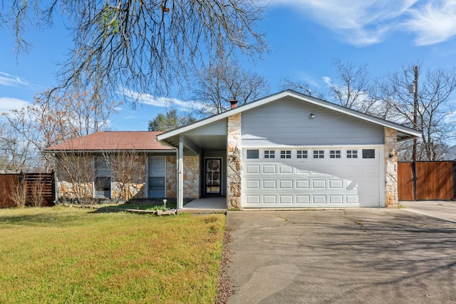 ranch-style home featuring a garage, fence, stone siding, concrete driveway, and a front lawn