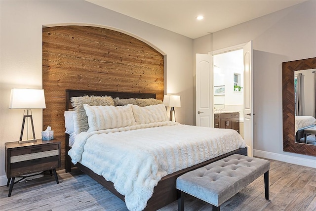 5608 Arroyo Rd, Austin, TX 78734 - bedroom with wood finished floors, ensuite bathroom, and recessed lighting