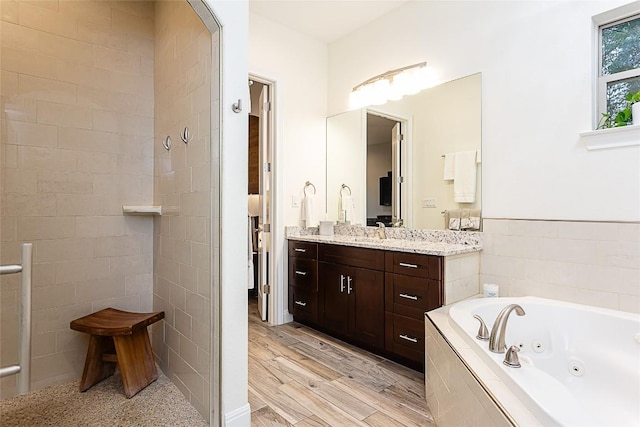 5608 Arroyo Rd, Austin, TX 78734 - bathroom featuring a whirlpool tub, vanity, a walk in shower, and wood finished floors