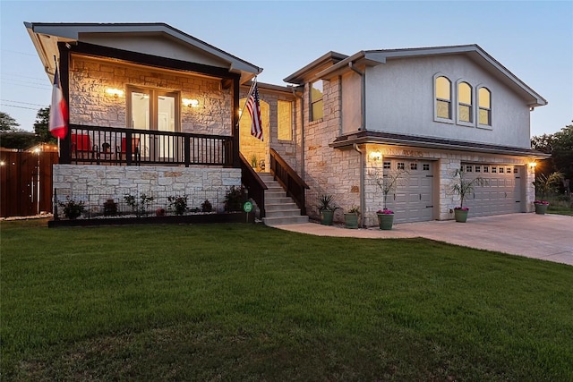 view of front of property featuring a garage, driveway, stone siding, a front lawn, and stucco siding