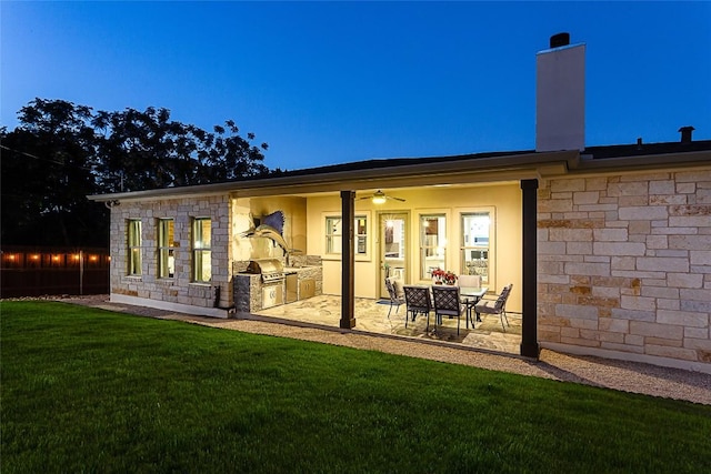 5608 Arroyo Rd, Austin, TX 78734 - rear view of house featuring an outdoor kitchen, a yard, a patio, a chimney, and ceiling fan