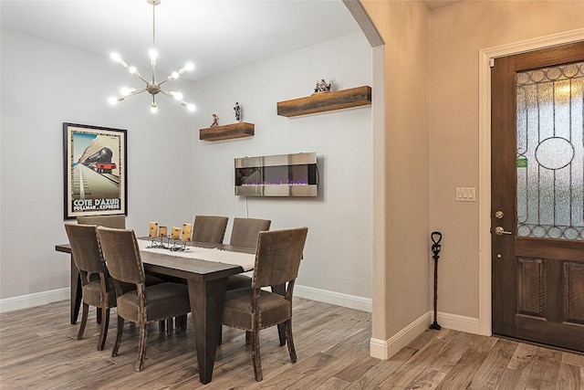 5608 Arroyo Rd, Austin, TX 78734 - dining space with wood finished floors, arched walkways, and a chandelier