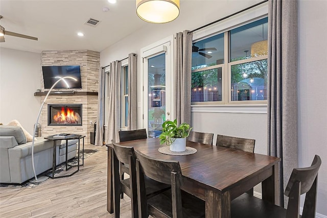 5608 Arroyo Rd, Austin, TX 78734 - dining room featuring a ceiling fan, light wood-style flooring, a large fireplace, and recessed lighting