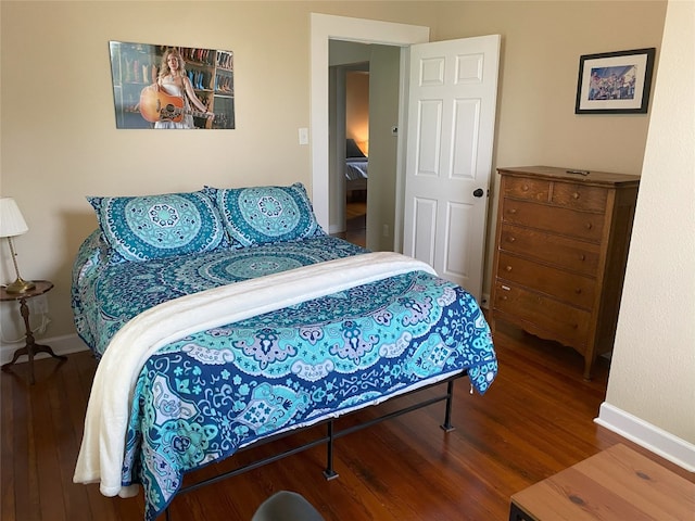 bedroom featuring baseboards and wood finished floors