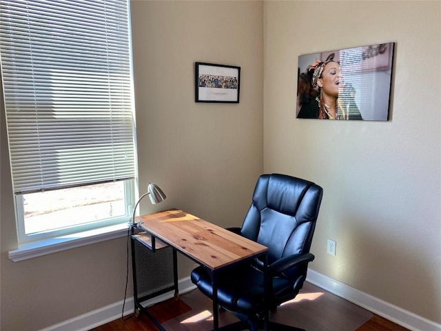 office space featuring baseboards and wood finished floors