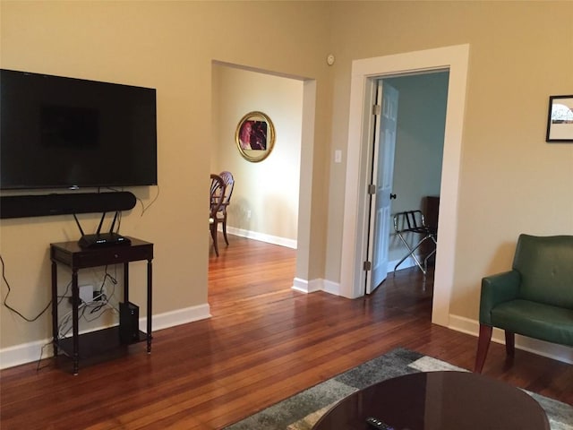 living room featuring baseboards and wood finished floors