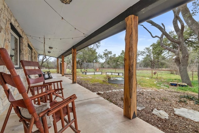 view of patio featuring fence