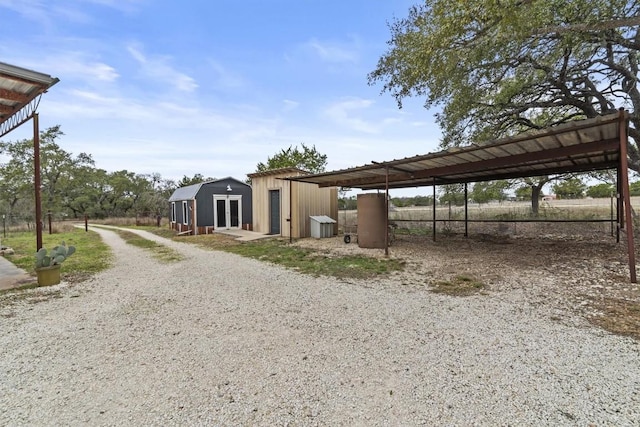 exterior space with gravel driveway and an outbuilding